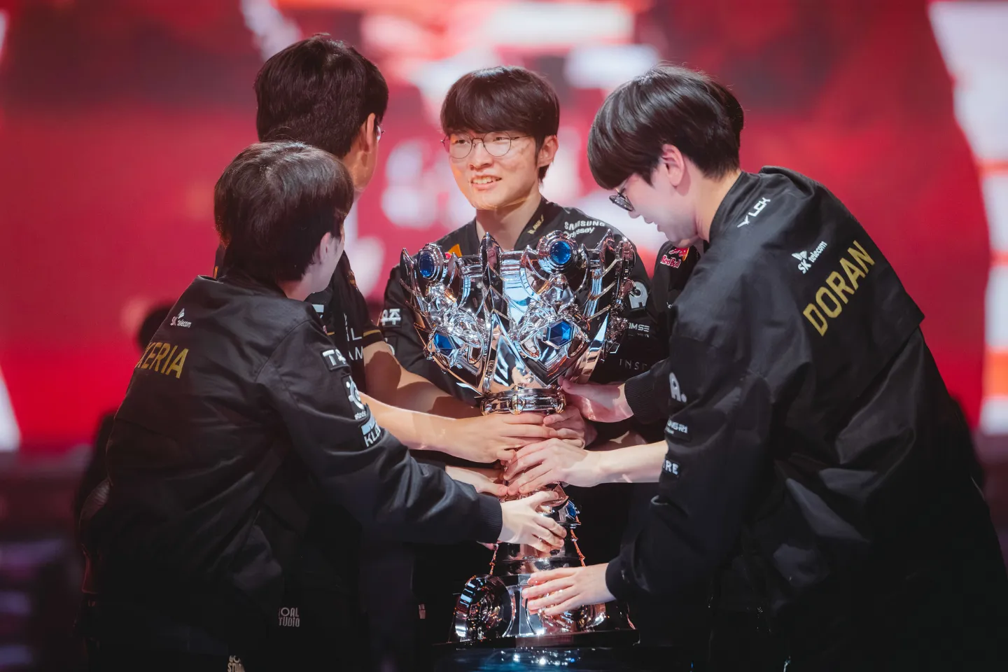 T1 lift the trophy onstage after being crowned champions at League of Legends Worlds 2025